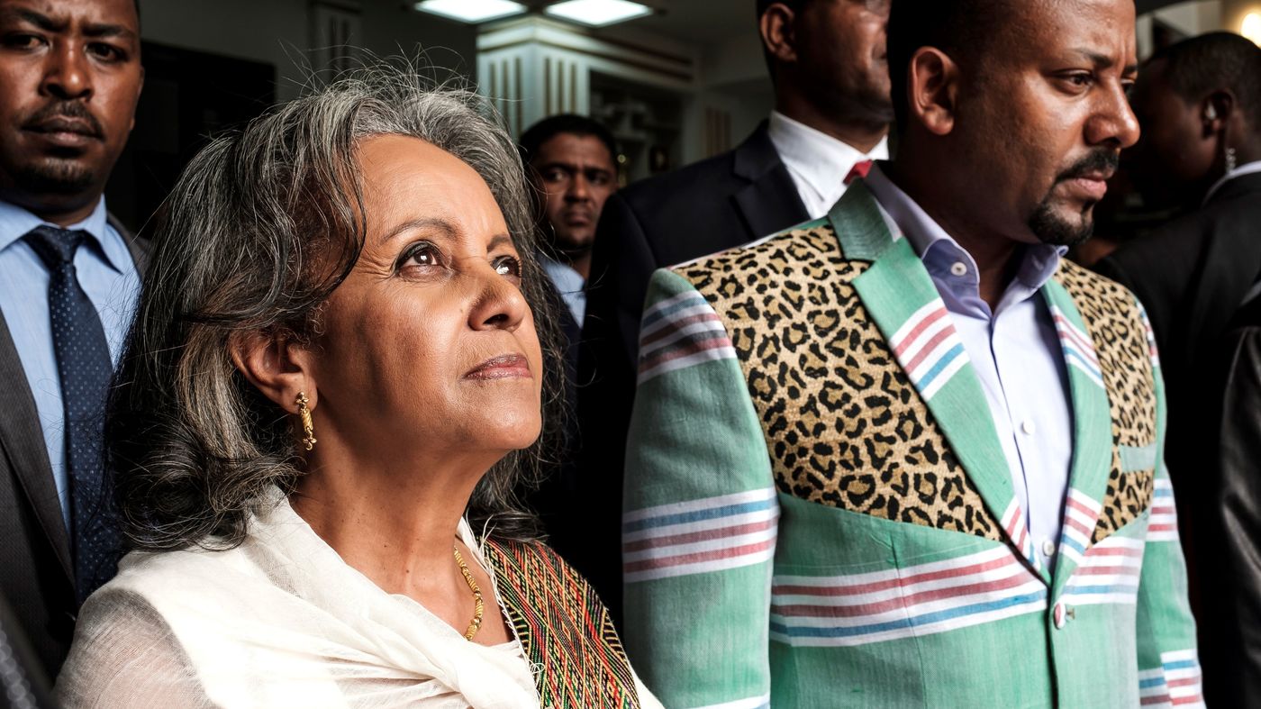 Sahle-Work Zewde walks with Prime Minister Abiy Ahmed after being appointed Ethiopia's first female president at the country's parliament in Addis Ababa on Thursday. Eduardo Soteras/AFP/Getty Images - new president