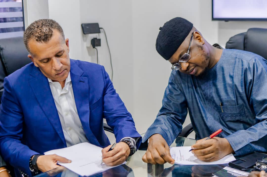 Microsoft representative (L) and Mr Pantami signing the Mou (Photo credit: @PofIsaPantamiTwitter)