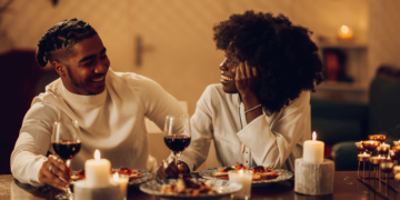 couple enjoying a Valentine's Day dinner at a beautifully decorated table featuring African cuisine.